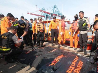 Equipes de resgate com corpos de algumas das vítimas. Reuters