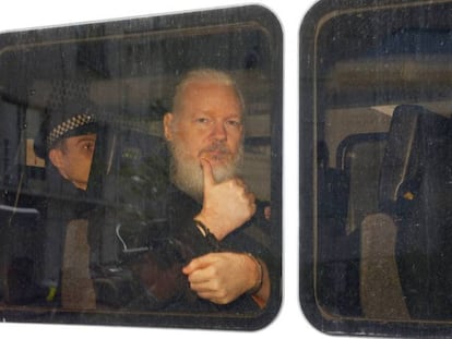Julian Assange em uma van da polícia após ser preso na embaixada equatoriana em Londres