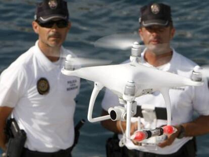 Agentes de la Policía Local de Benidorm con el dron que sirve para vigilar el litoral.