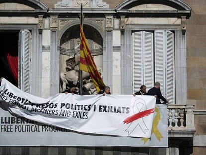 Pancartas en el palacio de la Generalitat que Quim Torra tuvo que retirar tras la decisión de la Junta Electoral. En vídeo, la ministra de Justicia asegura que la Fiscalía determinará si el comportamiento de Torra es constitutivo de delito.