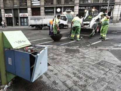 Operarios municipales limpian este sábado las calles de Barcelona. En vídeo, las pérdidas en mobiliario urbano se acercan a los dos millones de euros.
