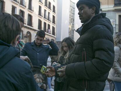 Un vendedor ilegal ofrece petardos a una familia en el centro de Madrid el pasado sábado. En vídeo, los perros perciben el ruido de los petardos tres veces más fuerte que los humanos