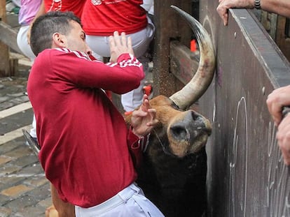 A runner is hit by a bull during Sunday’s Sanfermines.