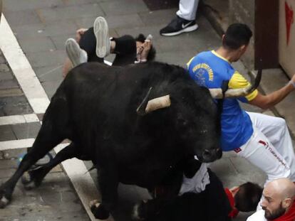 Uno de los toros de Fuente Ymbro engancha a un joven su paso por Estafeta, en el que cuarto encierro de los Sanfermines 2017. Vídeo: así ha sido el encierro.