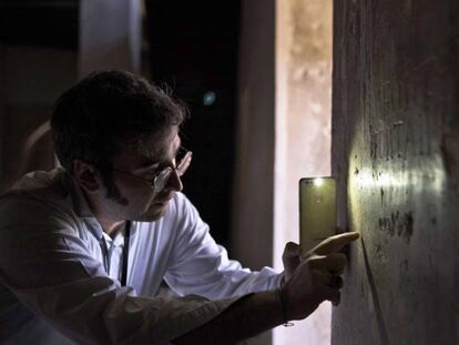 El historiador Alejandro Martín muestra los grafitos del palacio de la Aljafería.