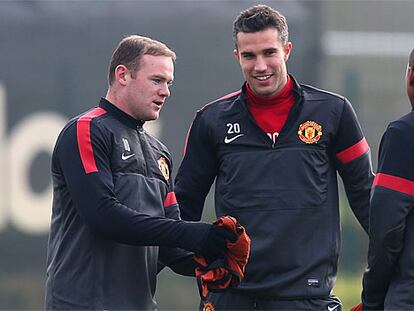 Rooney habla con Van Persie y Young durante el entrenamiento de ayer en Carrington.