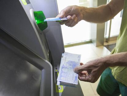 Una mujer utiliza un cajero automático en Madrid.