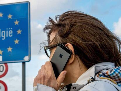 Una mujer usa su móvil en la frontera franco-belga.