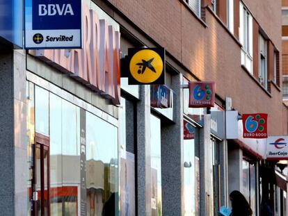 Varias sucursales de diferentes bancos en una calle de Sanchinarro, en Madrid. En vídeo, declaraciones del ministro de Economía.