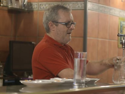 Un hombre sirve una jarra de agua en un bar. En vídeo, entrevista a la portavoz de la OCU.