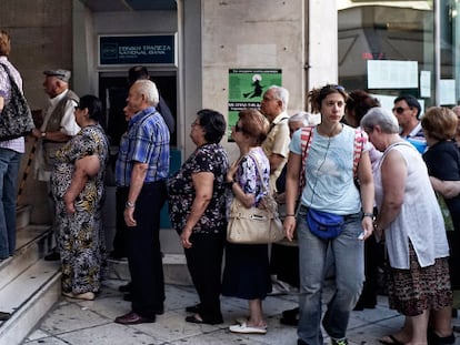 Griegos a las puertas de una oficina bancaria en Atenas.