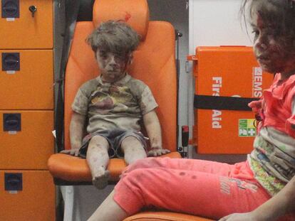 El niño sirio de cinco años de edad Omran Daqneesh, junto a su hermana, tras sobrevivir a un ataque aéreo en Alepo. Su rostro ensangrentado se ha convertido en viral.