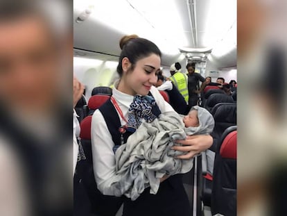 Una auxiliar de vuelo sostiene a la bebé que nació durante el vuelo.