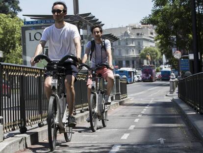 Dos jóvenes circulan en bicicletas públicas BiciMad por el carril bici de la calle de Alcalá, donde ocurrió un atropello mortal.