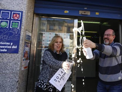 El venedor de l'administració de la plaça Major de Sabadell mostra el tercer premi que ha venut.
