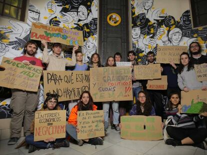 Un grupo de jóvenes en el CS La Ingobernable (Madrid) junto a los carteles con los que irán a la huelga climática del 15M.