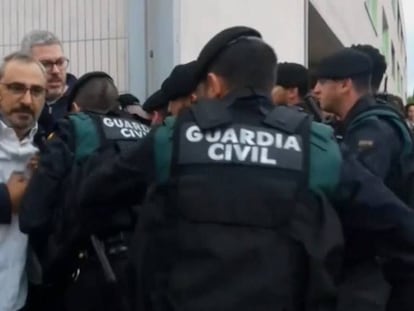 Captura de pantalla de uno de los vídeos mostrados en la sesión del juicio del 'procés' de este martes. En vídeo, La Guardia Civil intenta acceder a un colegio retirando a la gente que se concentra en la puerta el 1-O.