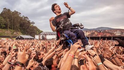 A man in a wheelchair is raised up by the crowd at Resurrection Fest.