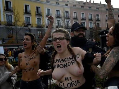 Dos agentes intentan frenar la protesta de las integrantes de Femen en Madrid.