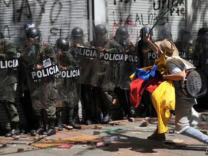 Un manifestante se enfrenta a la policía.