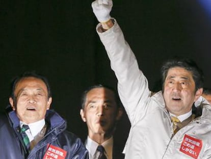 El primer ministro Shinzo Abe (derecha) levanta el puño durante la campaña electoral, en Tokio