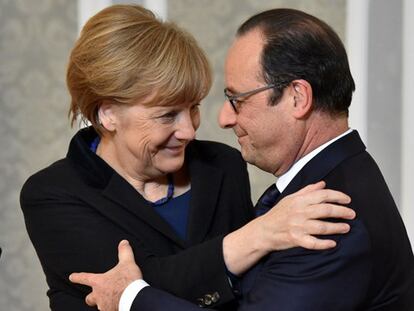 Merkel y Hollande se abrazan al término de la cumbre.