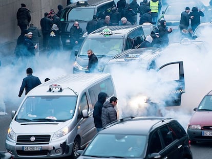 Policías antidisturbios y taxistas en el Periférico de París este martes.