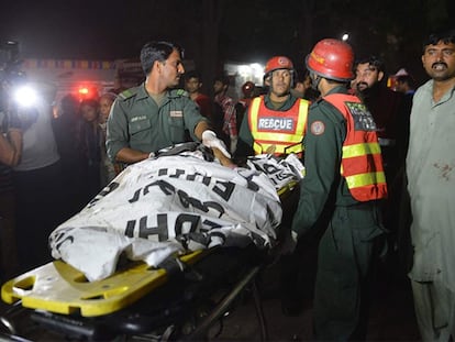 Serviços de emergência levam o corpo de uma das vítimas.