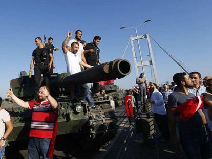Policías y ciudadanos turcos, sobre un vehículo militar involucrado en el golpe, en el puente del Bósforo de Estambul.