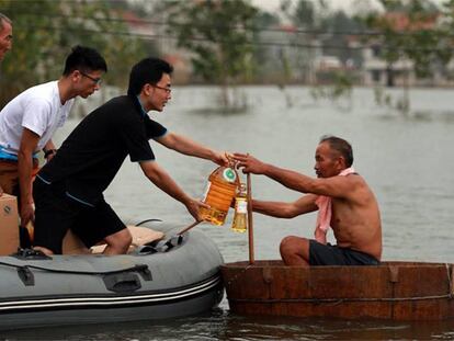Un grupo de voluntarios ayuda a un hombre en la provincia de Hubei.
