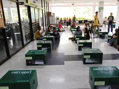 Un policía observa las urnas para la votación del referéndum, en Bangk