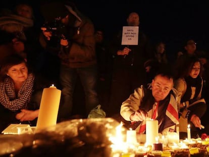 Gente enciende velas en la vigilia en recuerdo a las víctimas, este jueves