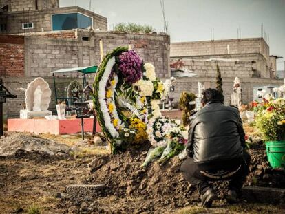 Homem visita túmulo de mulher assassinada em Ecatepec.