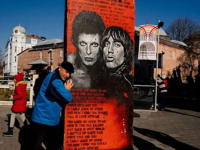 Un hombre posa con una sección del Muro de Berlín en una exposición de arte callejero en Plovdiv, el pasado 12 de enero. En vídeo, el reportaje completo.