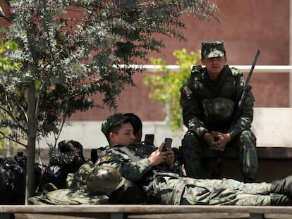 Soldados ecuatorianos toman un descanso a las puertas de la Asamblea Nacional. En vídeo, el país vuelve a la normalidad tras la derogación del 'paquetazo'.