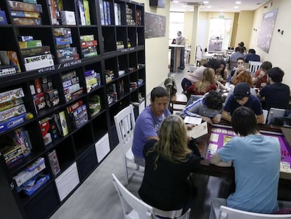 Un grupo de personas juegan a distintos juegos de mesa en Epic Board Game Cafe, en Madrid.
