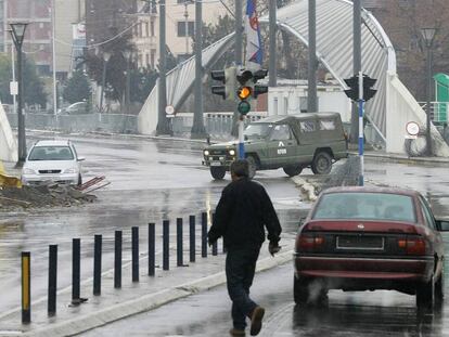 Vehículo sin matrícula circulando por Mitrovica Norte, la parte serbia de la ciudad, al fondo, el puente de Mitrovica, que separa la comunidad albanesa de la serbia en esta ciudad de Kosovo.