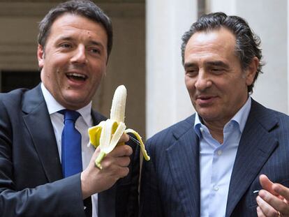 Italian Prime Minister Matteo Renzi and Italian national soccer team coach Cesare Prandelli share a banana in support of Dani Alves.