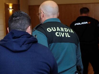 Un guardia civil escolta al acusado en la Audiencia Provincial vallisoletana.