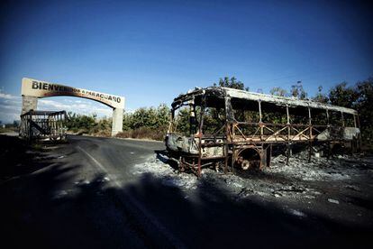 Restos de un autobus incendiado por miembros del crimen organizado, a la entrada de la comunidad de Parácuaro, en Michoacán.