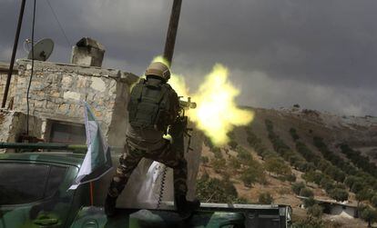 Combatiente rebelde sirio de una facción favorable a Turquía dispara una ametralladora pesada durante las maniobras de entrenamiento para la inminente operación turca contra las milicias kurdas del norte de Siria.