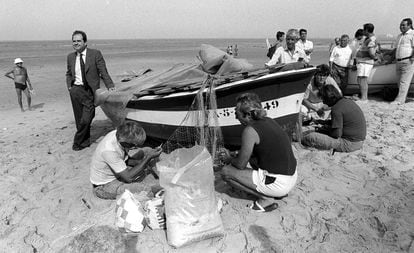 Manuel Chaves, junto a unos pescadores en la playa de la Victoria, en Cádiz, durante la campaña electoral en junio de 1990.