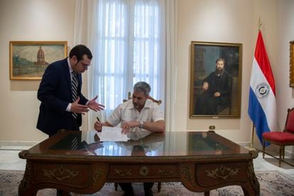 Paraguayan President Mario Abdo Benitez signs a resolution at the presidential residence after the interview.