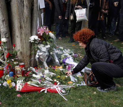 Una mujer sitúa una vela en el lugar donde se suicidó el individuo.