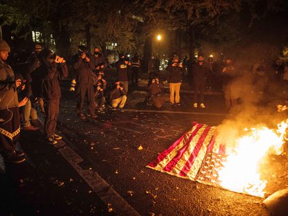 Manifestantes queman bandera estadounidense en Portland. En vídeo, protestas tras la noche electoral.