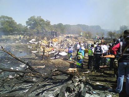 The plane was due to take off as 1.20pm. But a sensor was overheating, prompting the pilot to return to the stand for a check. In the photo, the accident site after the fire caused by the crash was extinguished.