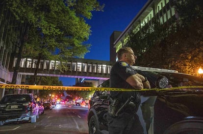 A police officer witnesses the vigil being held in honor of the victims of the downtown Sacramento shooting.