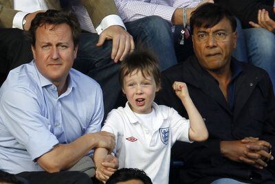 El primer ministro David Cameron con su hijo Arthur.