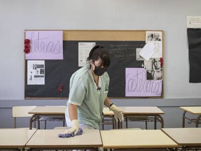 Una trabajadora del Instituto Juan Manuel Zafra de Barcelona limpiando una de las aulas.