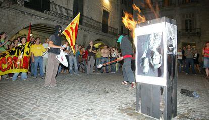 Dos encapuchados queman una foto de los Reyes frente al Ayuntamiento de Girona en septiembre de 2007.